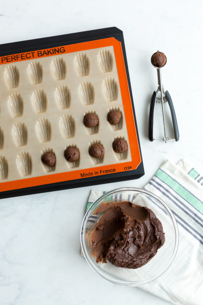 Adding Chocolate Matcha Madeleine batter to SIlpat Mini Madeleine Mold