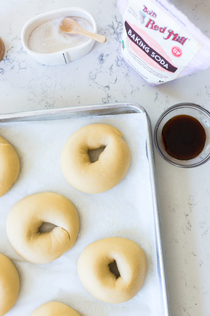 proofed bagels on a baking sheet