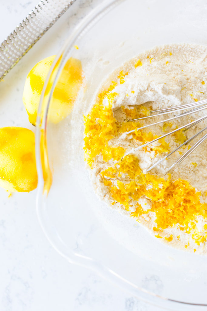 whisking lemon zest into dry cake ingredients