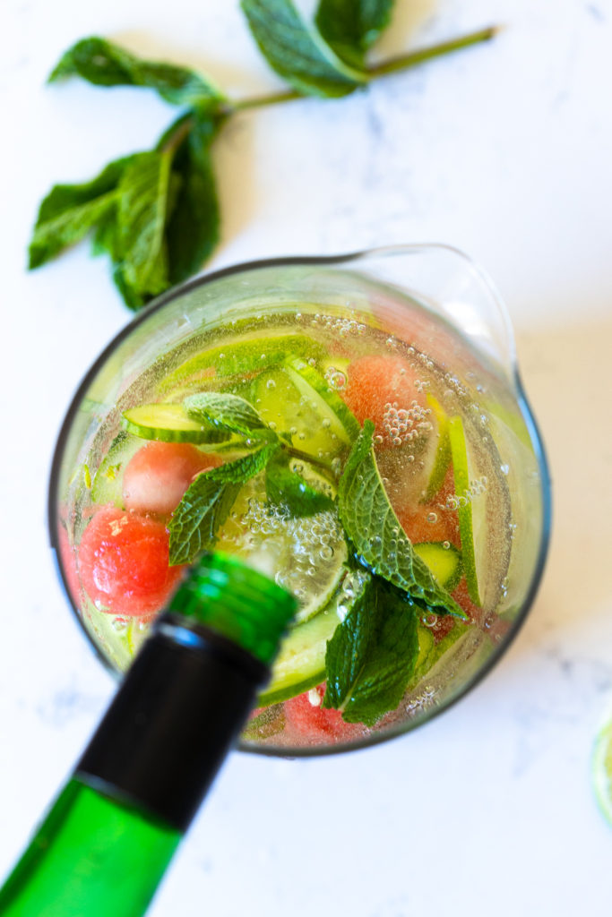 Adding white wine to sangria