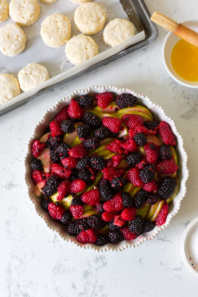 Pears and berries in dish for Pear Berry Cobbler