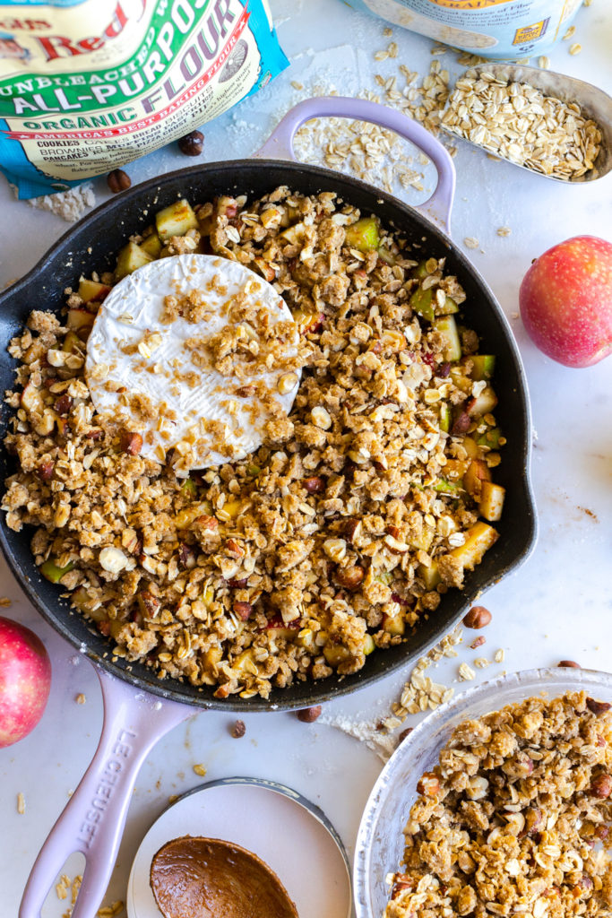 Brie and Apples getting topped with hazelnut crisp