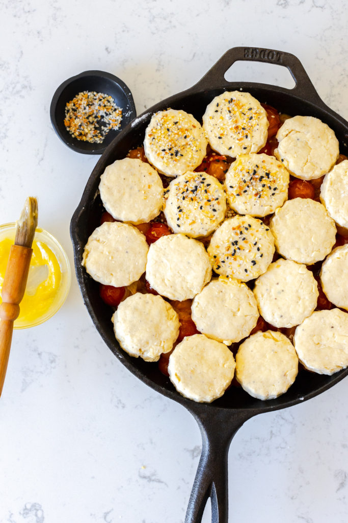 Assembling the Cherry Tomato Cobbler with Cheddar Everything Biscuits