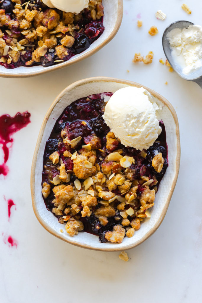 Mixed Berry Oat Almond Crisp with a scoop of vanilla ice cream