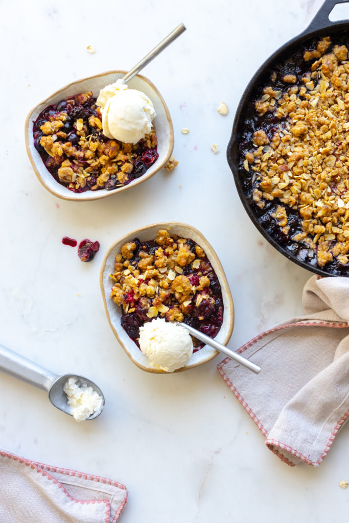 Mixed Berry Oat Almond Crisp served with vanilla ice cream