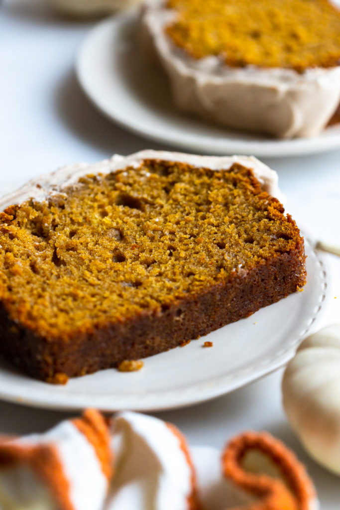 Slice of Pumpkin Spice Bread with Maple Cream Cheese Frosting