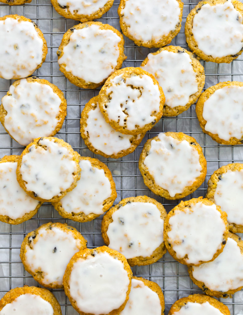 Iced Orange Currant Oatmeal Cookies from above arranged on a cookie sheet