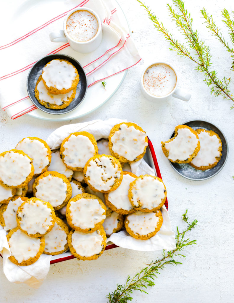Platter of Iced Orange Currant Oatmeal Cookies shot from above with decorative greenery