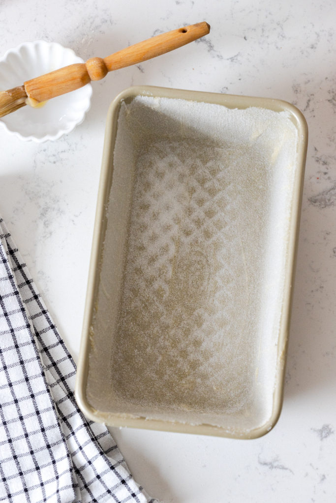 Buttering and sugaring a loaf pan