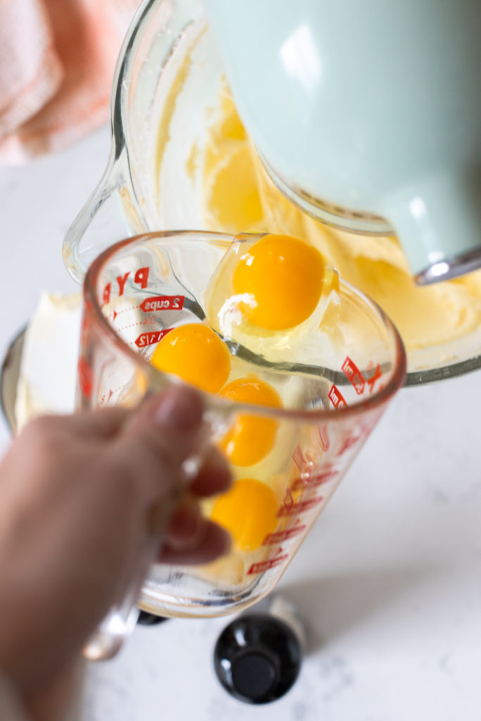 adding eggs to cake batter