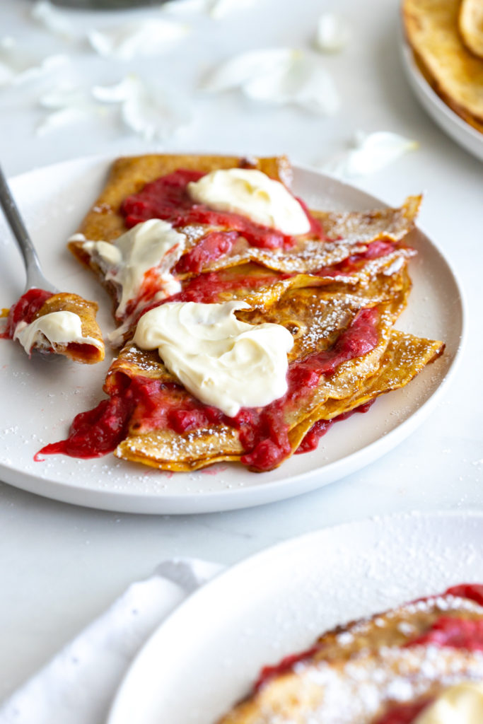 Plate of Rye Crepes and Rhubarb Raspberry Ginger Compote and crème fraîche