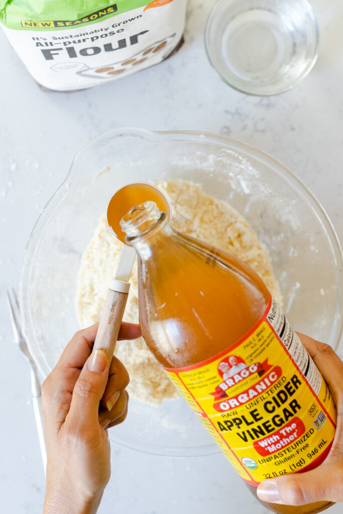 adding apple cider vinegar to the dough mixture