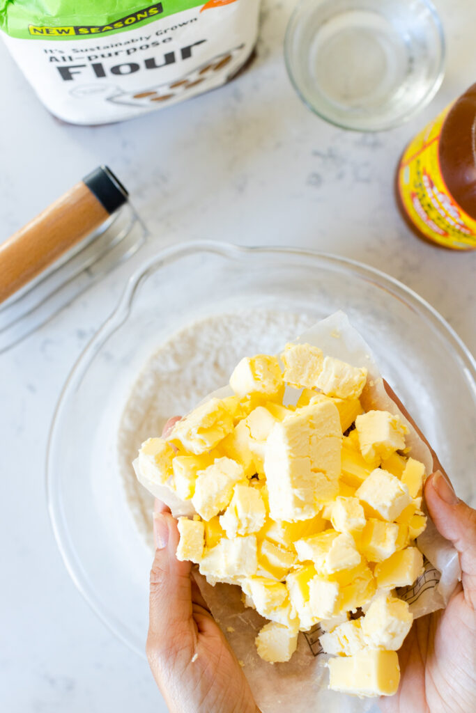 Small cold butter cubes for basic pie dough going into the mixing bowl