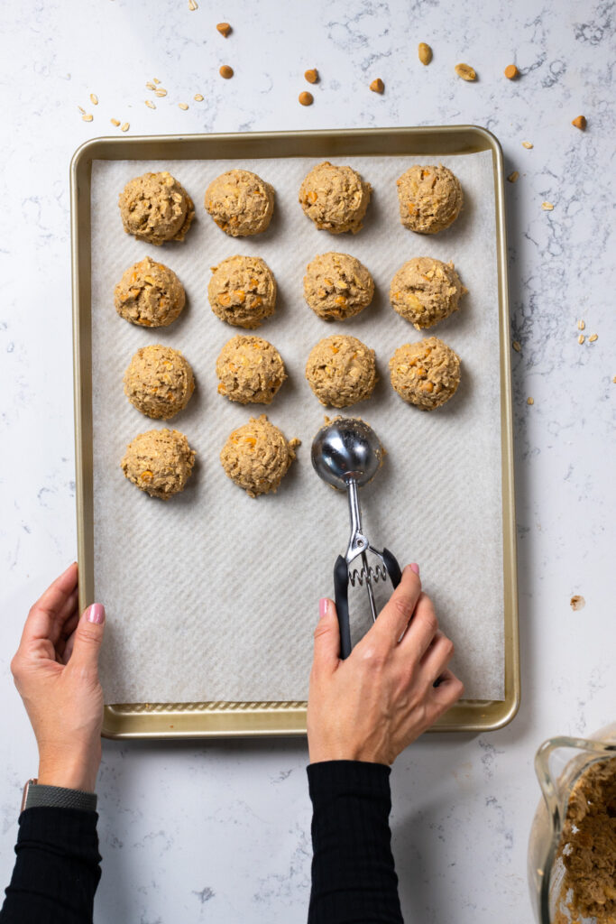Scooping Salted Peanut Butterscotch Oatmeal Cookie dough