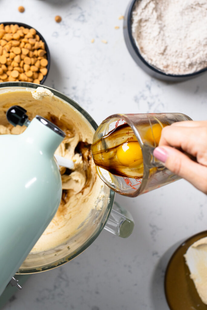 Adding eggs to cookie dough