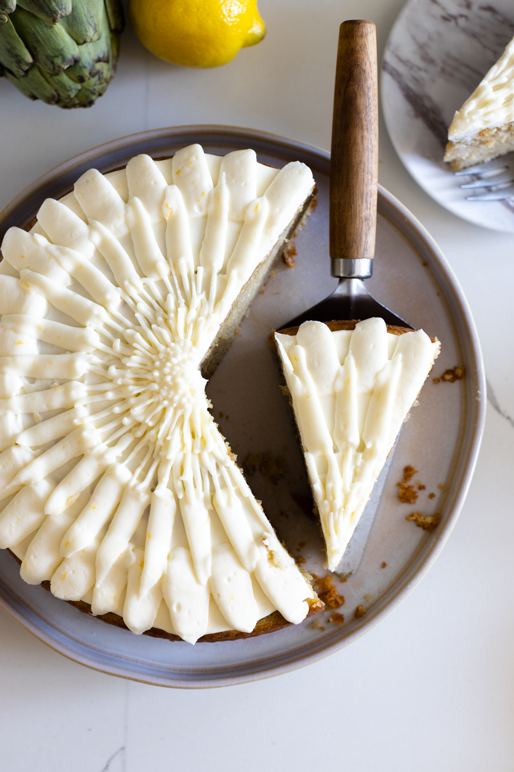 Slice of Artichoke Olive Oil Cake with Lemon Cream Cheese Frosting