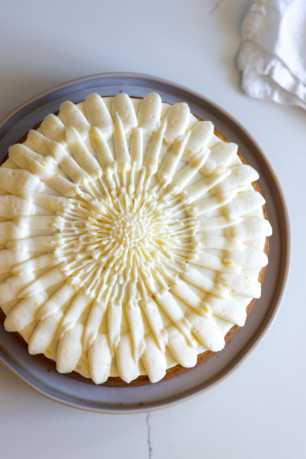 Close up of Artichoke Olive Oil Cake with Lemon Cream Cheese Frosting