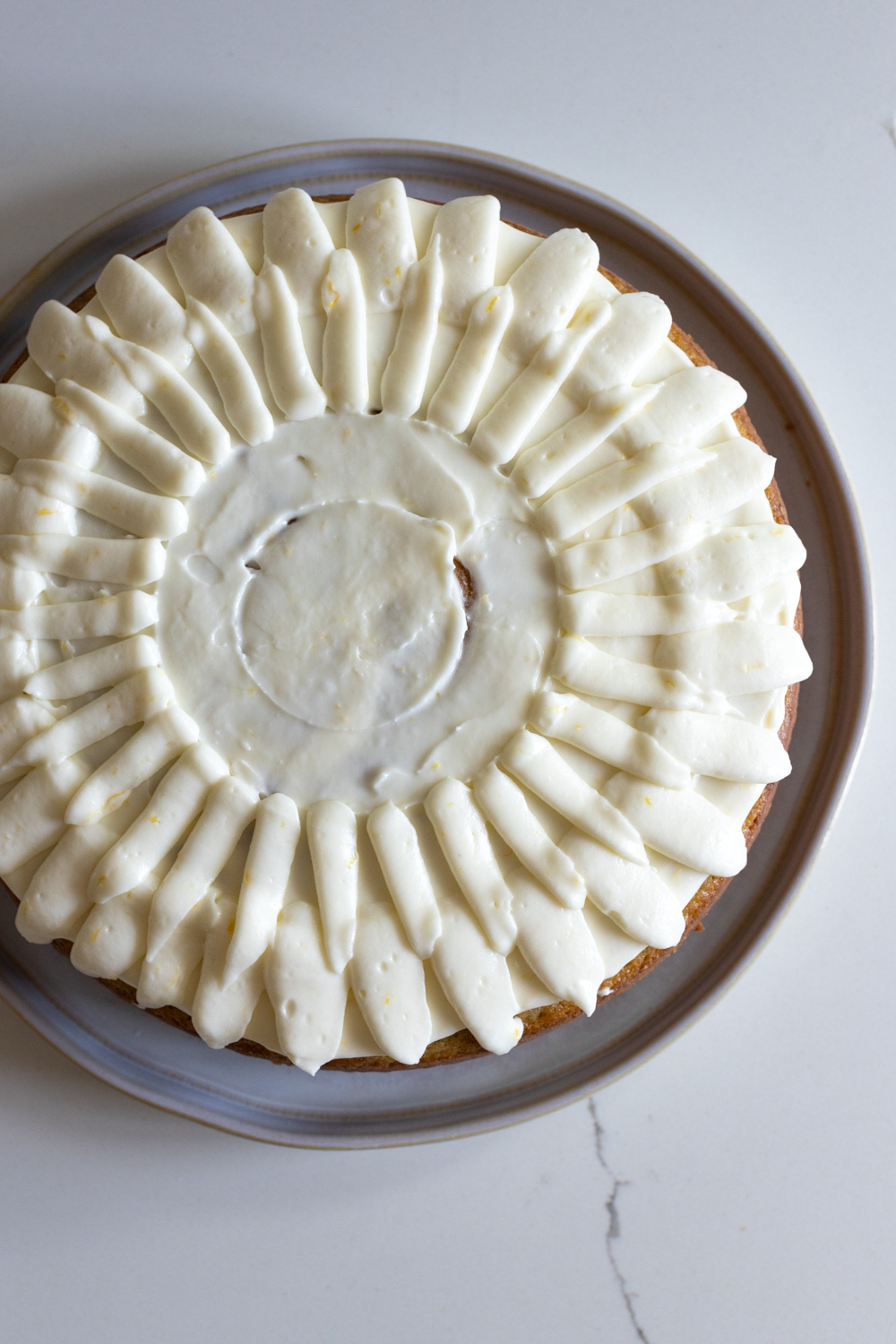 Decorating Artichoke Olive Oil Cake with Lemon Cream Cheese Frosting