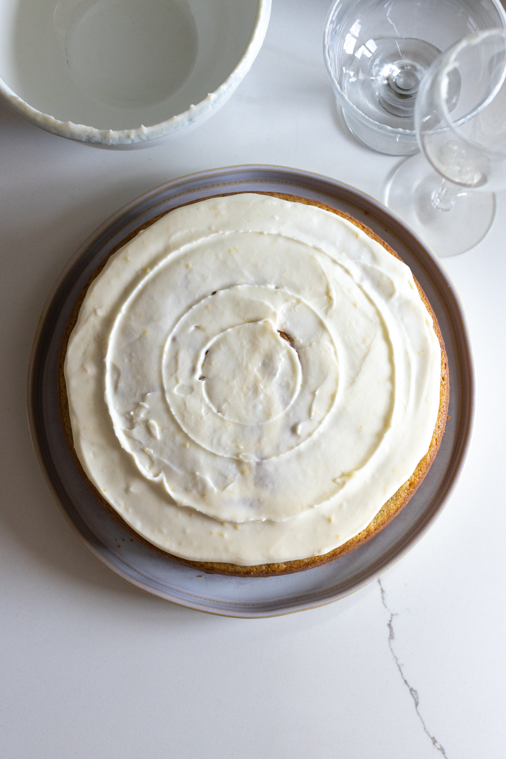 Decorating the Artichoke Olive Oil Cake with Lemon Cream Cheese Frosting