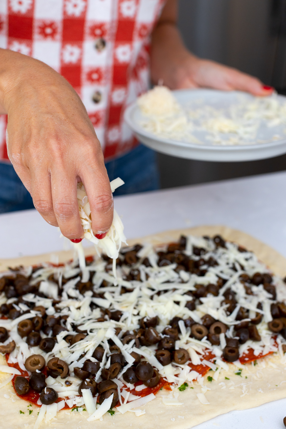Layering ingredients on Pepperoni Black Olive Stromboli