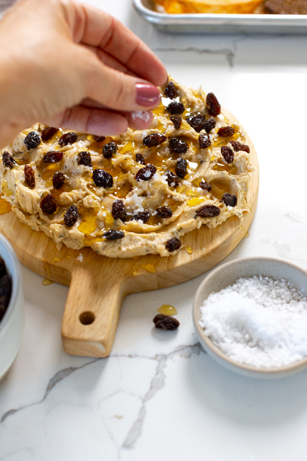 Adding salt to Cinnamon Raisin Honey Butter Board