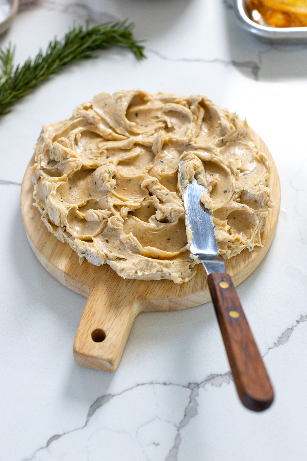 adding butter to butter board