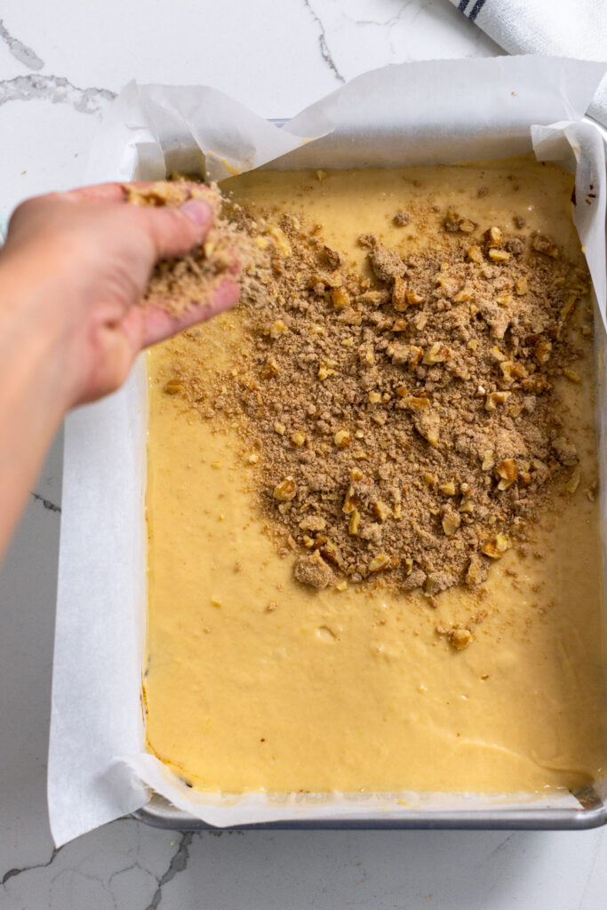 Step 4 adding crumble top to cake