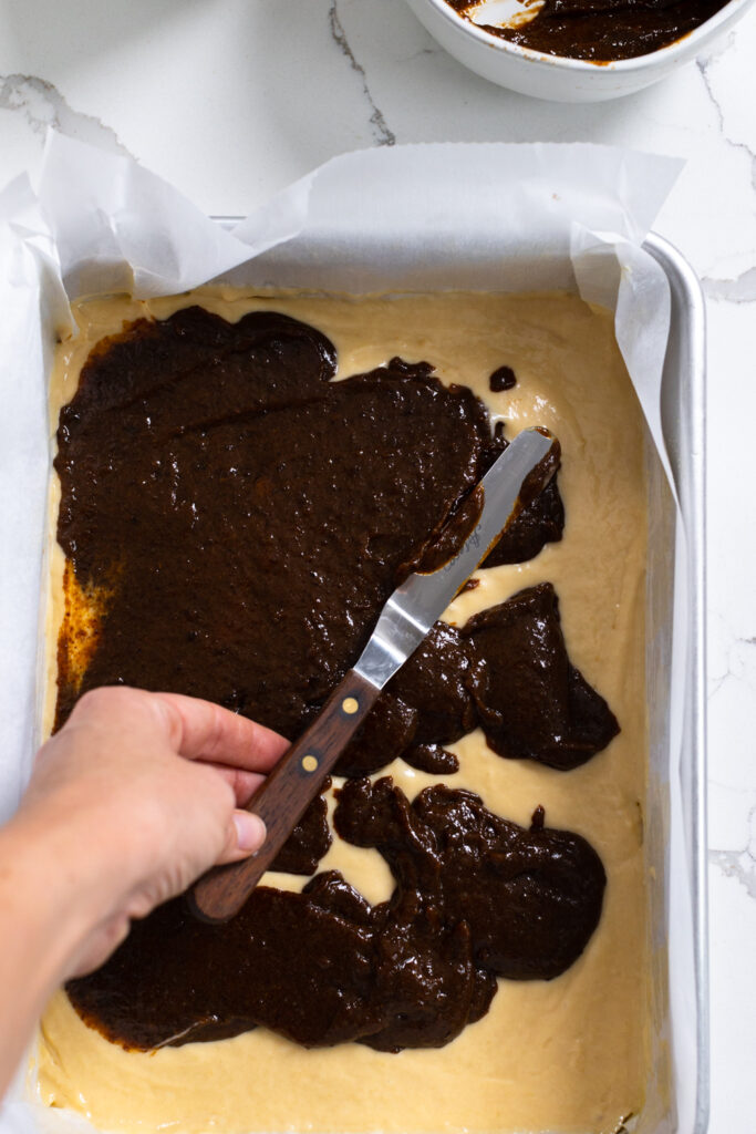 Step 2 is layering Spiced Prune Puree Filling on top of the first layer of coffee cake batter