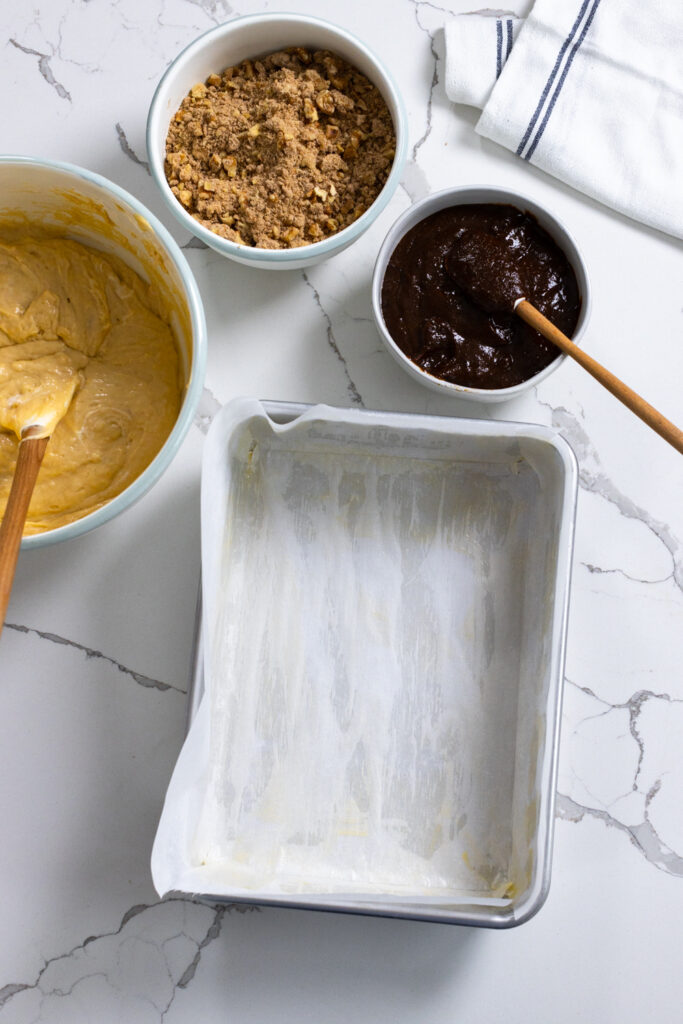 Spiced Prune Coffee Cake components about to be assembled into a parchment lined cake pan