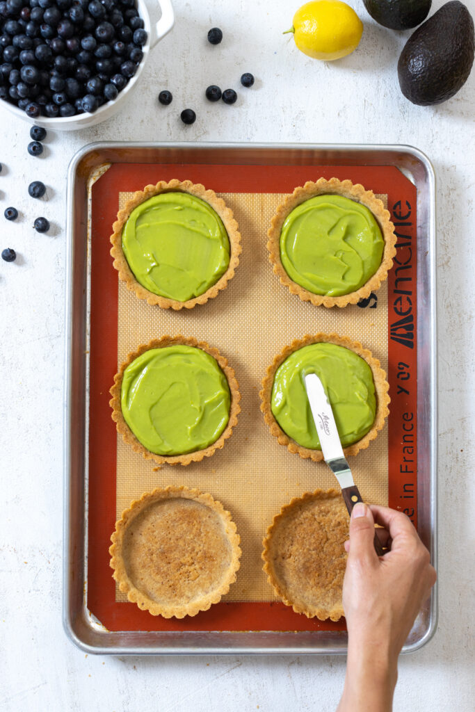 Smoothing avocado filling in almond tart shells