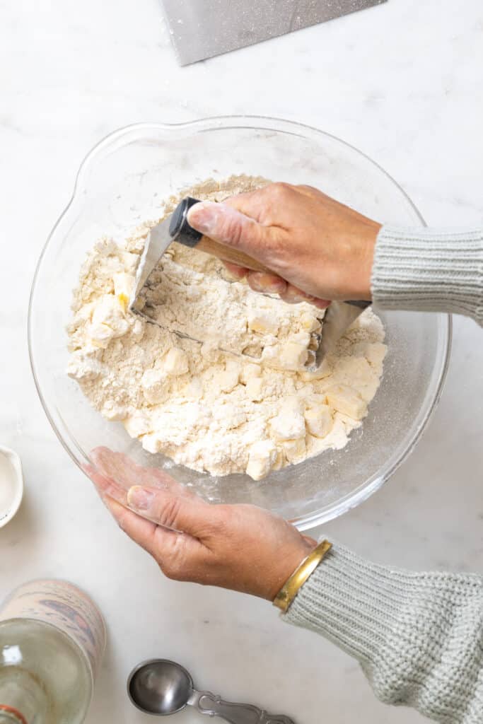 Cutting pie dough with hand pastry blender