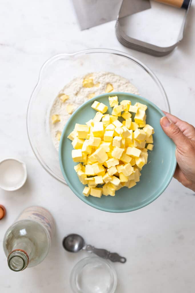 A close up of European style butter cut into 1cm cubes for pie dough recipe