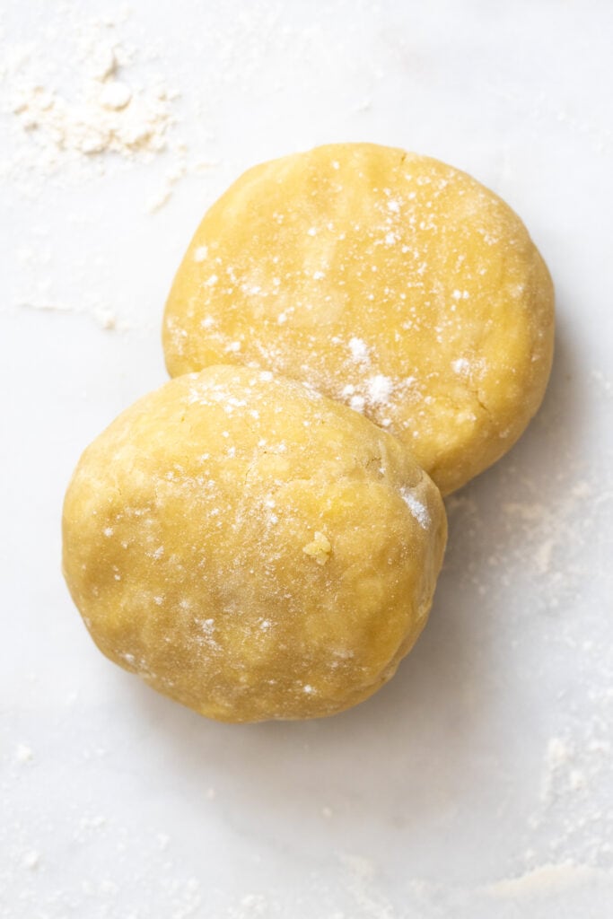 All Butter Vodka Pie Dough discs from above on marble surface