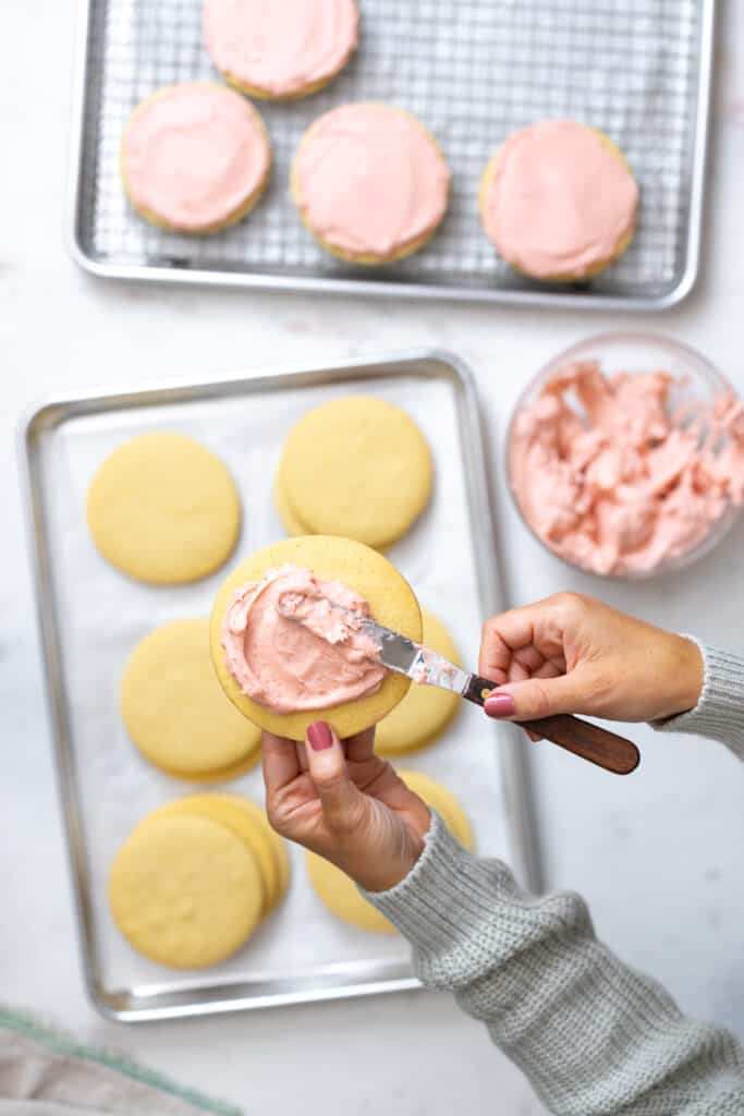 Spreading Strawberry Pink Cream Cheese Frosting