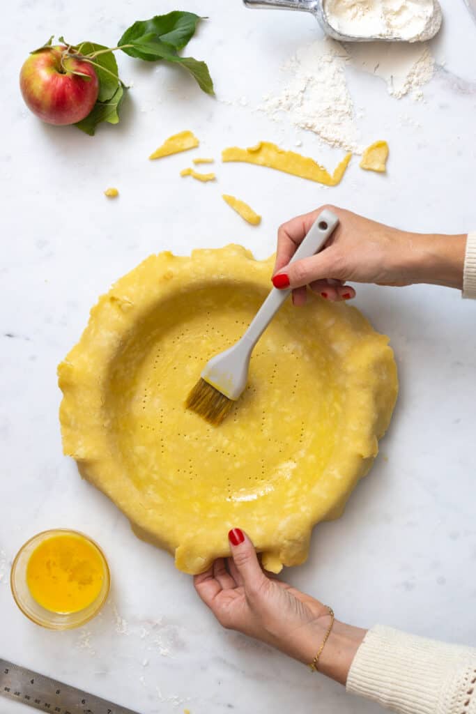 brushing pie shell with egg wash