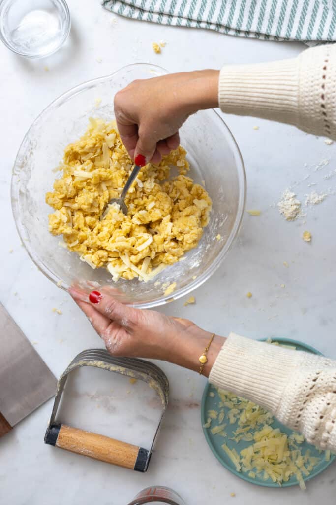 blending cheese into pie dough