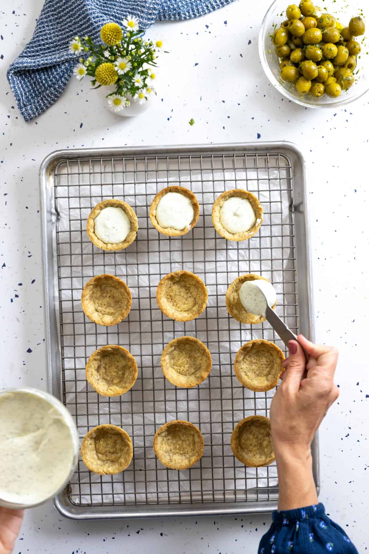Filling savory tartlet shells with goat cheese filling