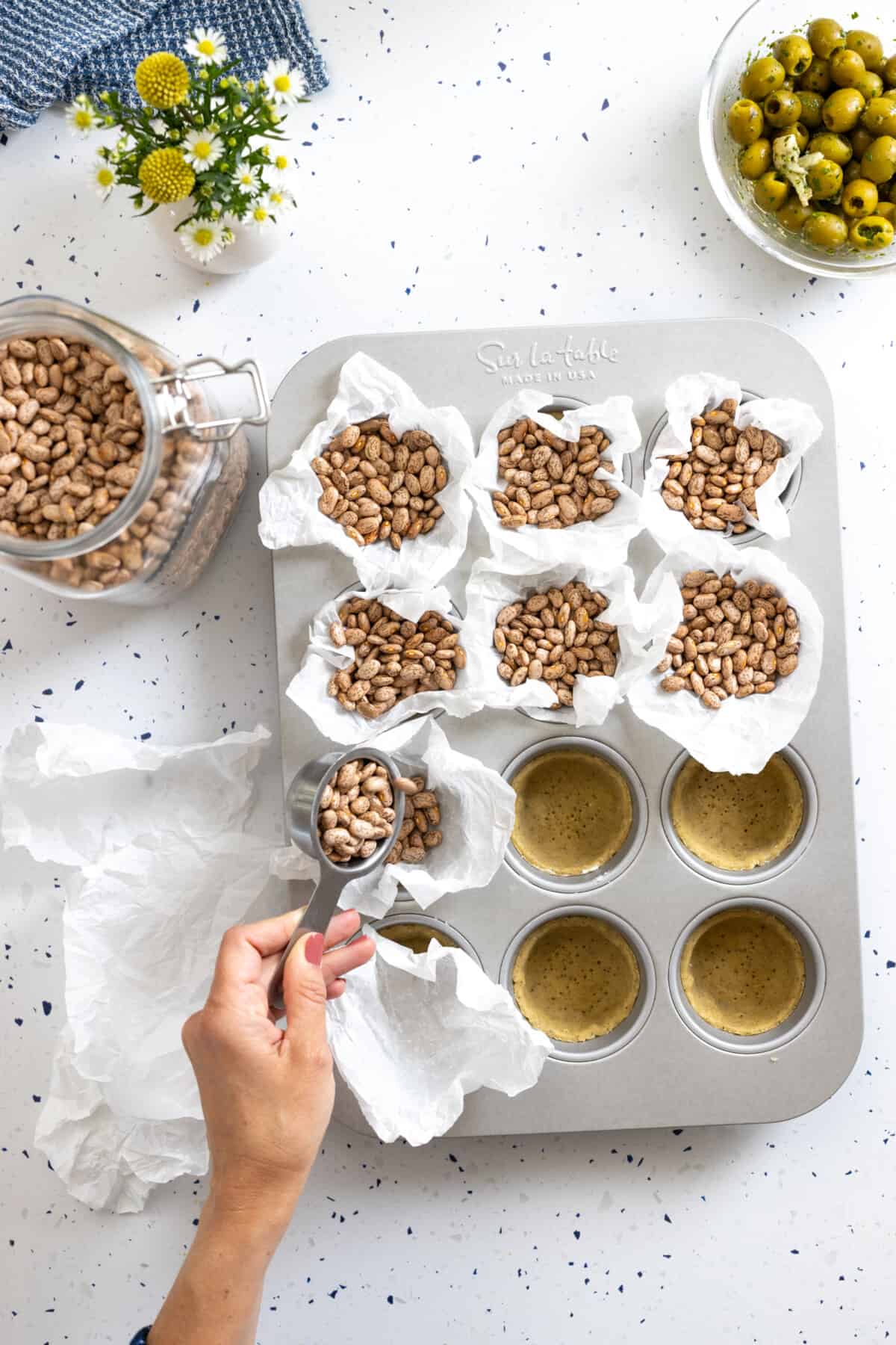 filling tartlet shells with beans for blind baking