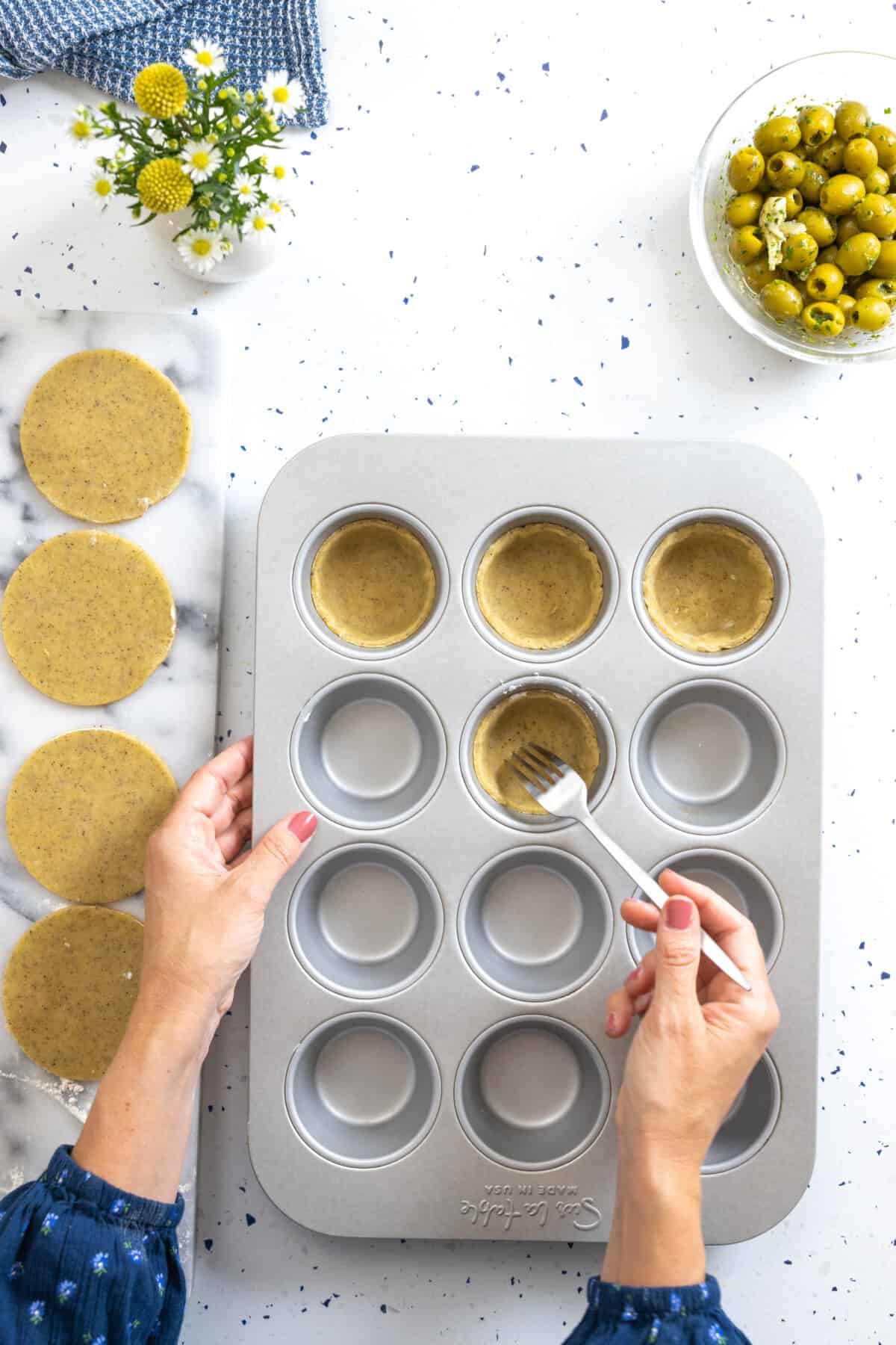 pricking tartlet dough with a fork