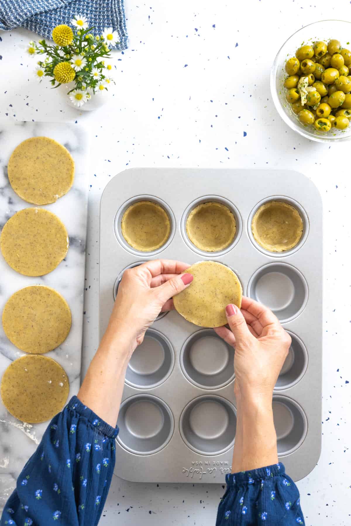 transfer tart dough rounds to muffin pan