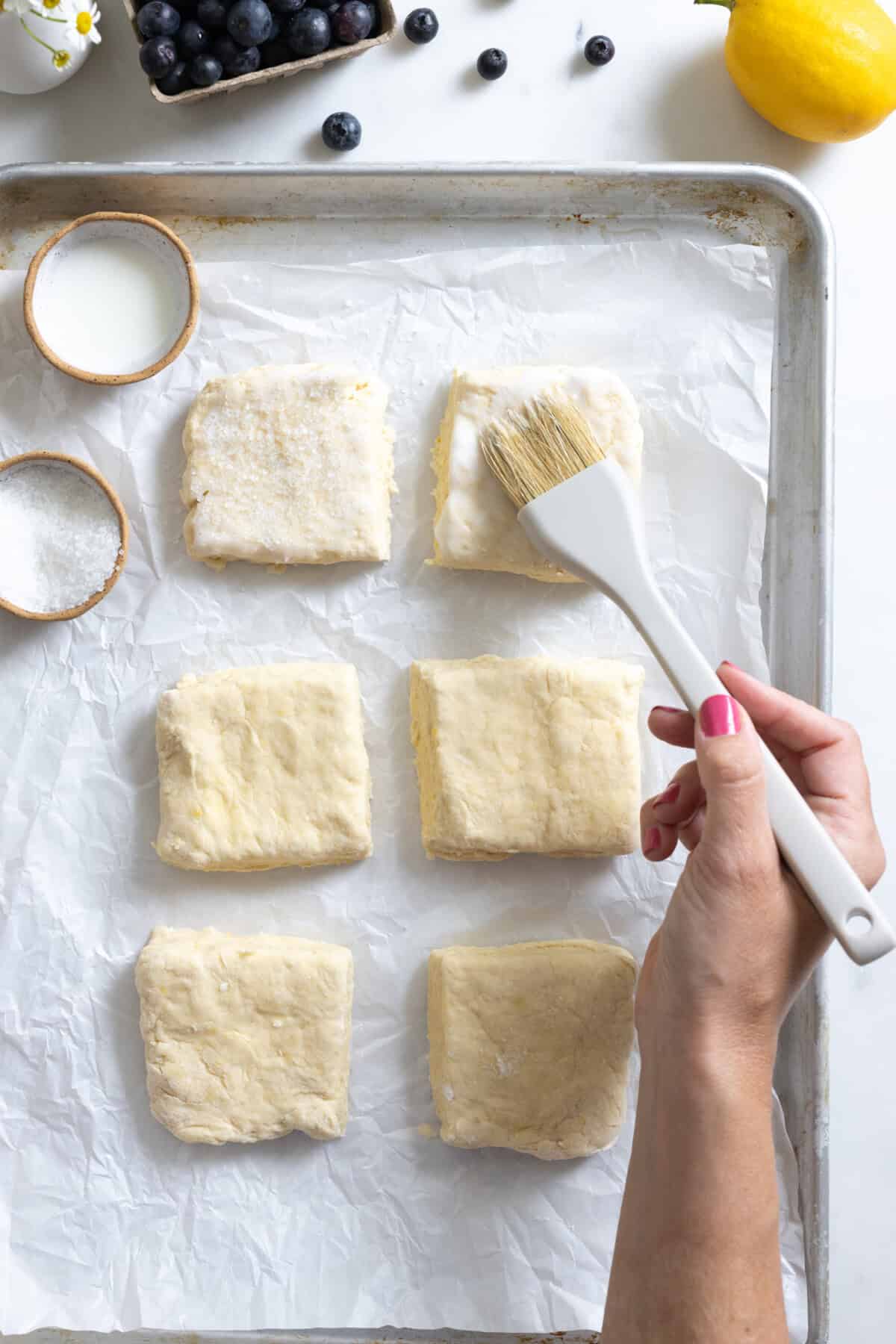 brushing shortcakes with buttermilk