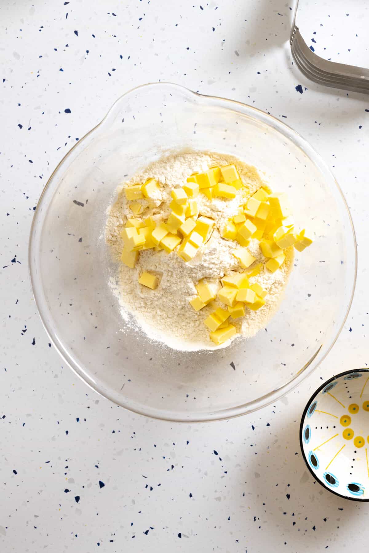 Adding cold cubed butter to dry ingredients