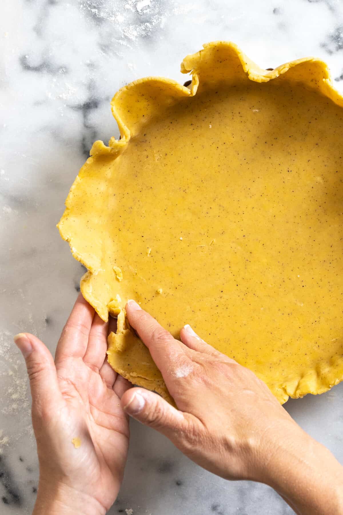 adding dough to tart pan