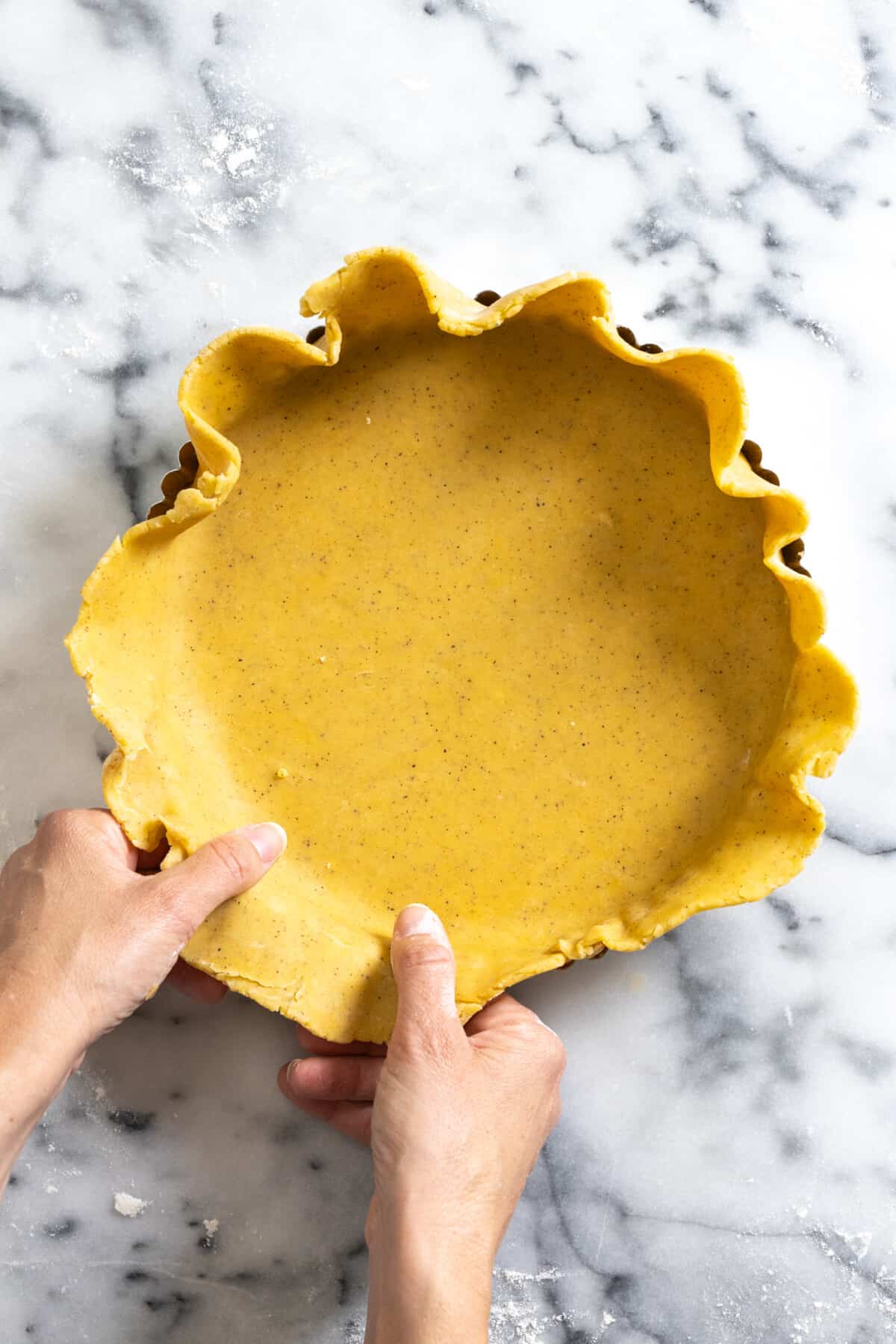 adding dough to tart pan