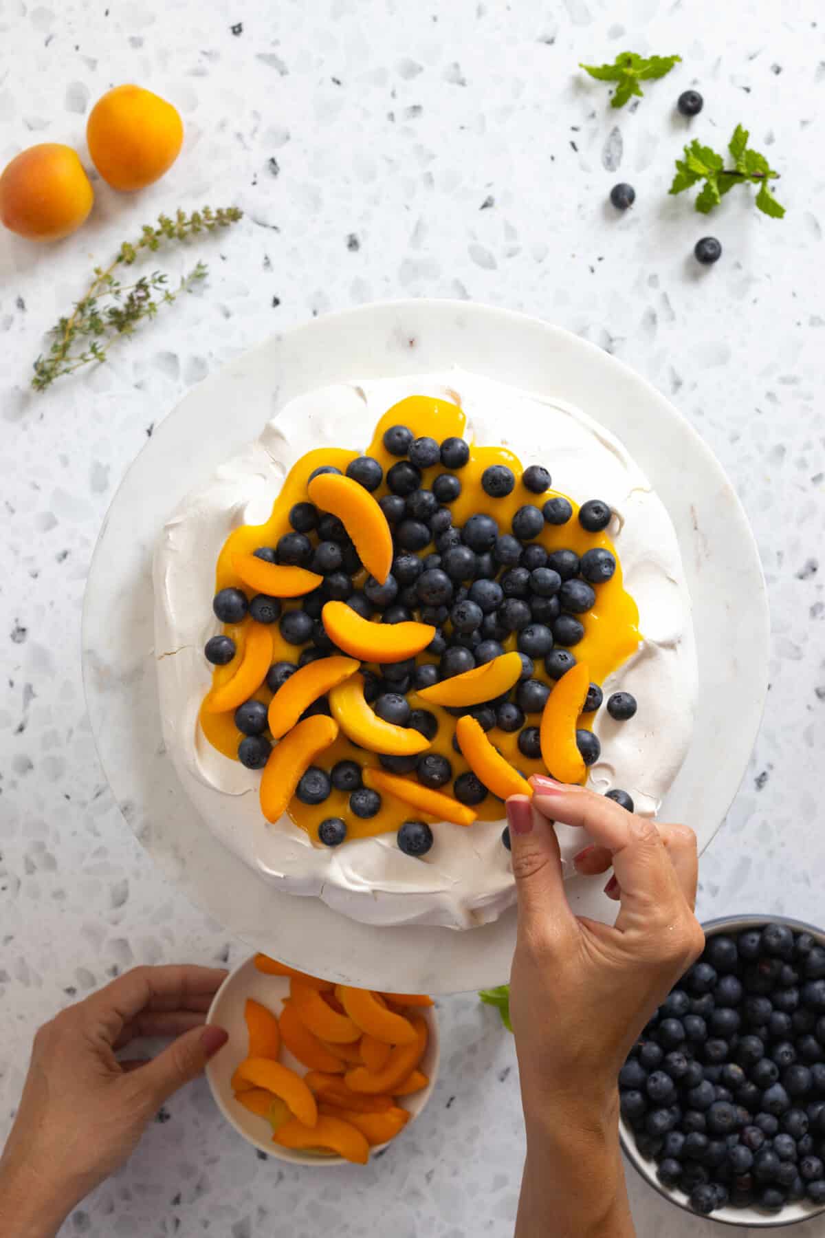 Adding apricots to Pavlova