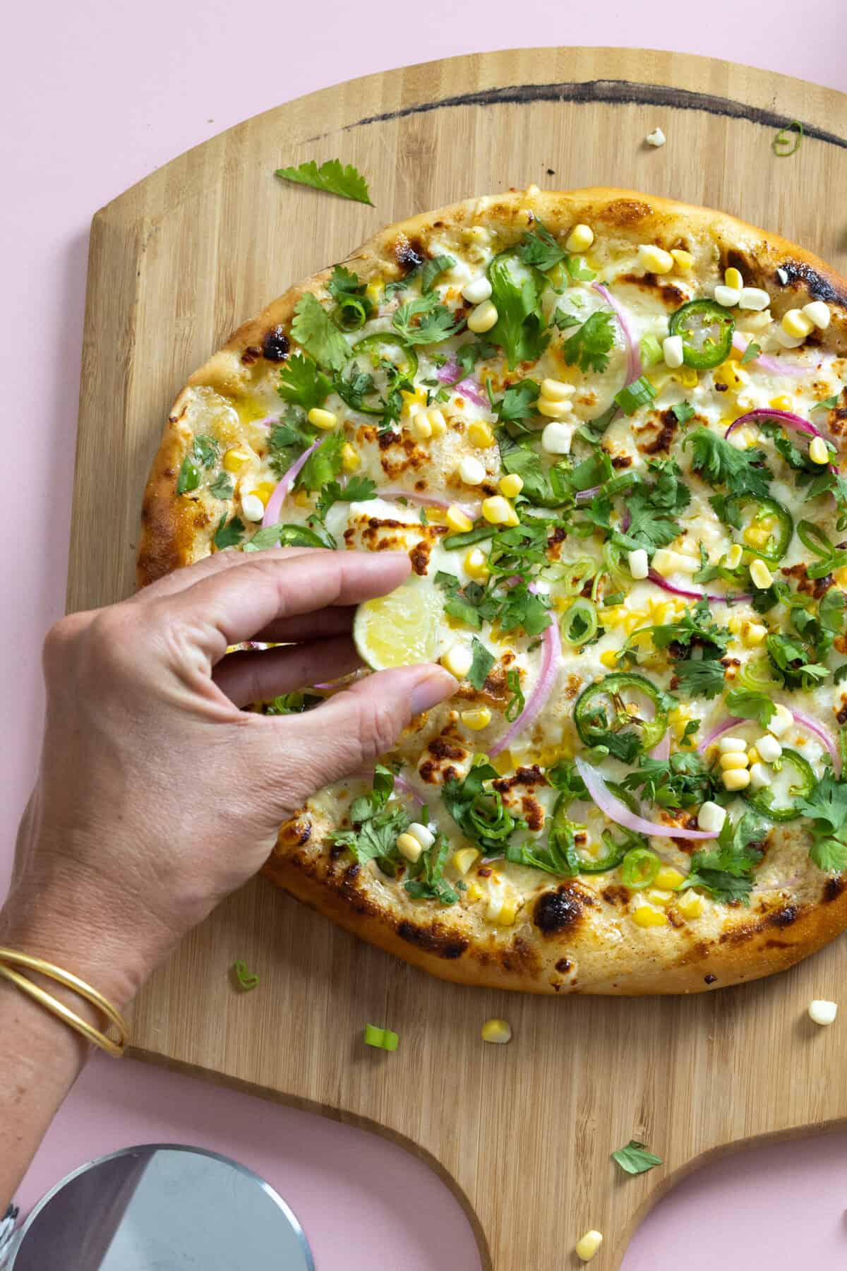 Squeeze some fresh lime juice on top of the Elote Pizza just before serving.