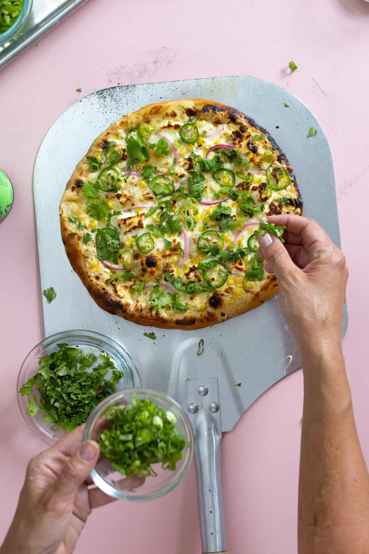 add herbs to the freshly baked pizza