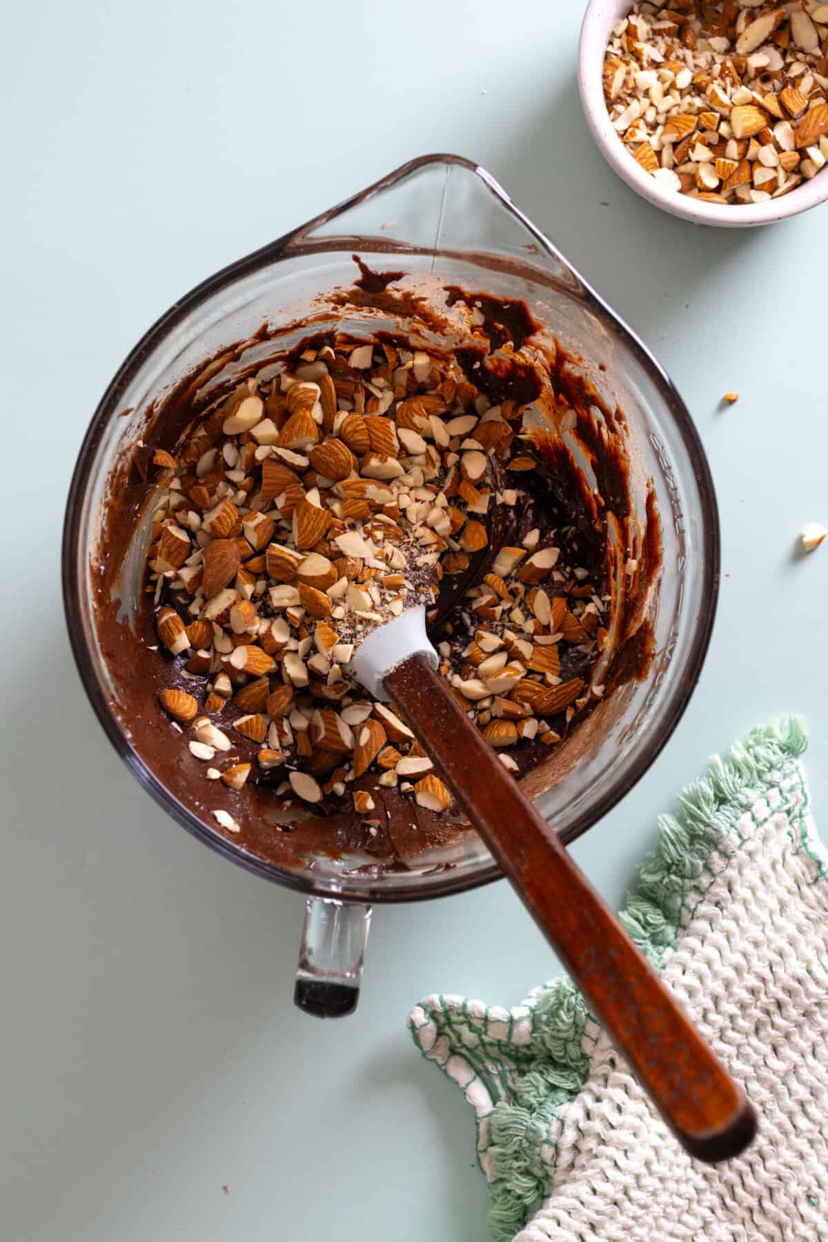 adding almonds to brownie batter