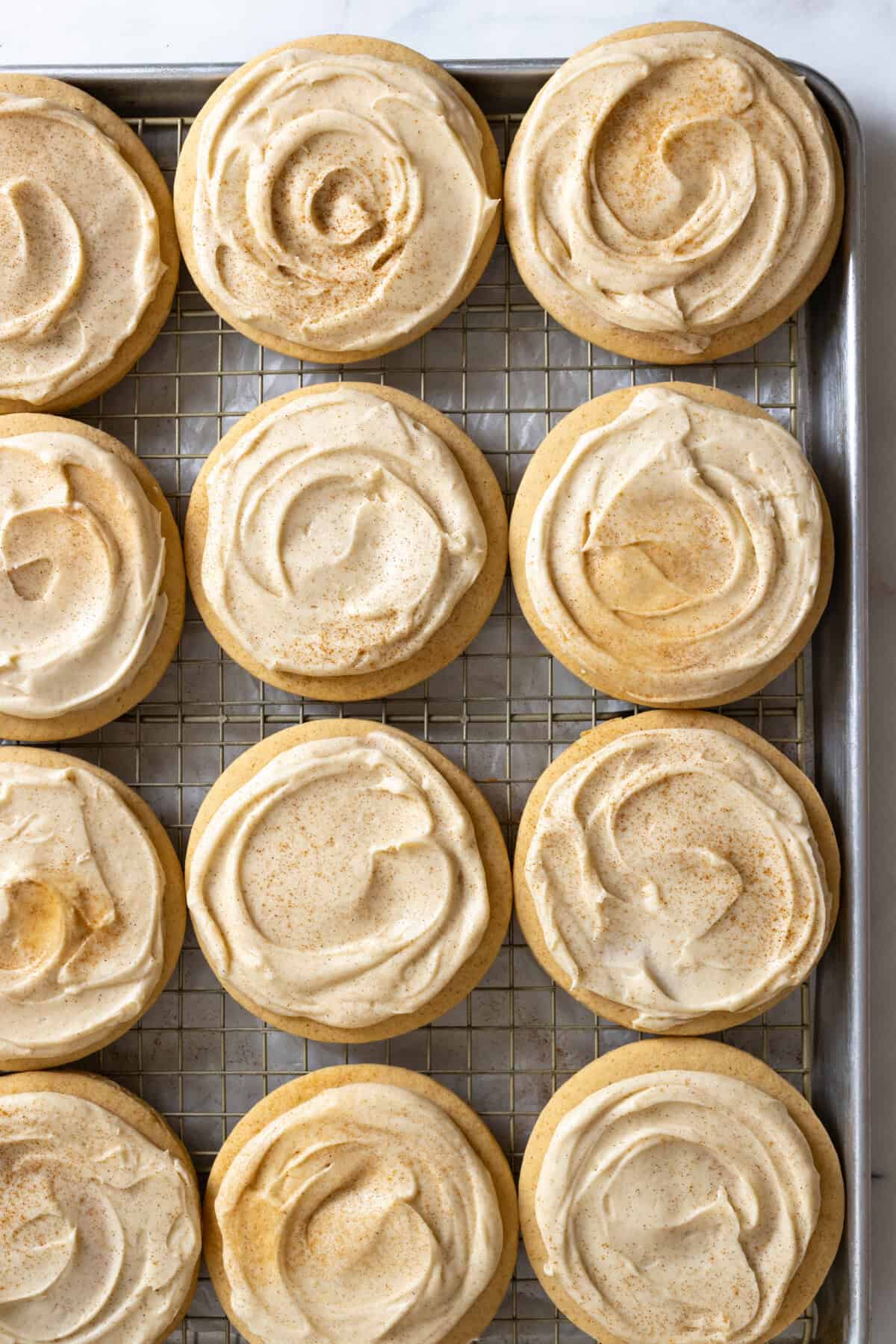Dust Big Maple Cream Cheese Frosted Cookies with cinnamon