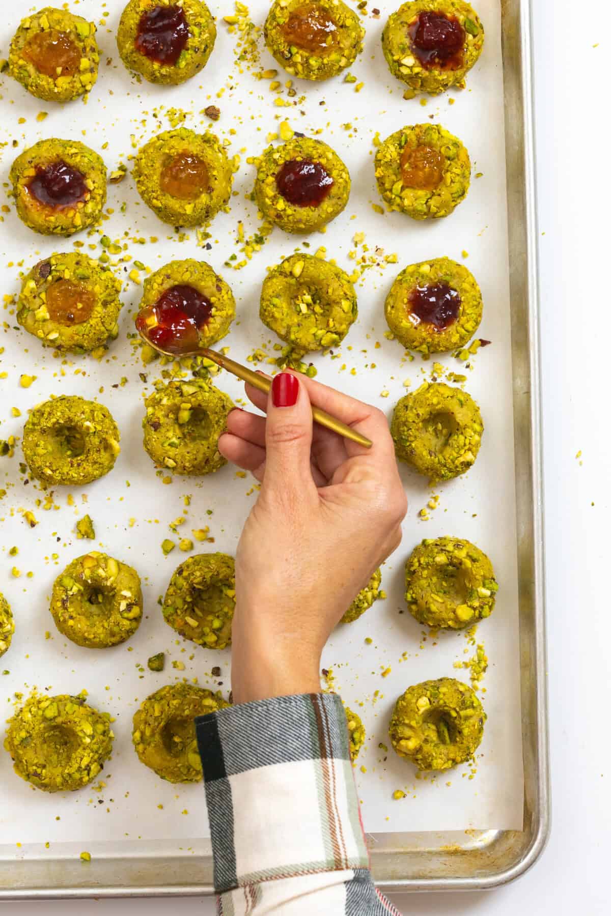 filling thumbprint cookies with jam